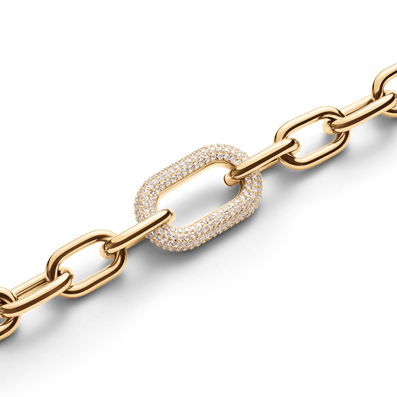 Gold chain-link bracelet with a pavé crystal accent link, featuring polished links and a modern, adjustable design suitable for stacking or everyday wear.