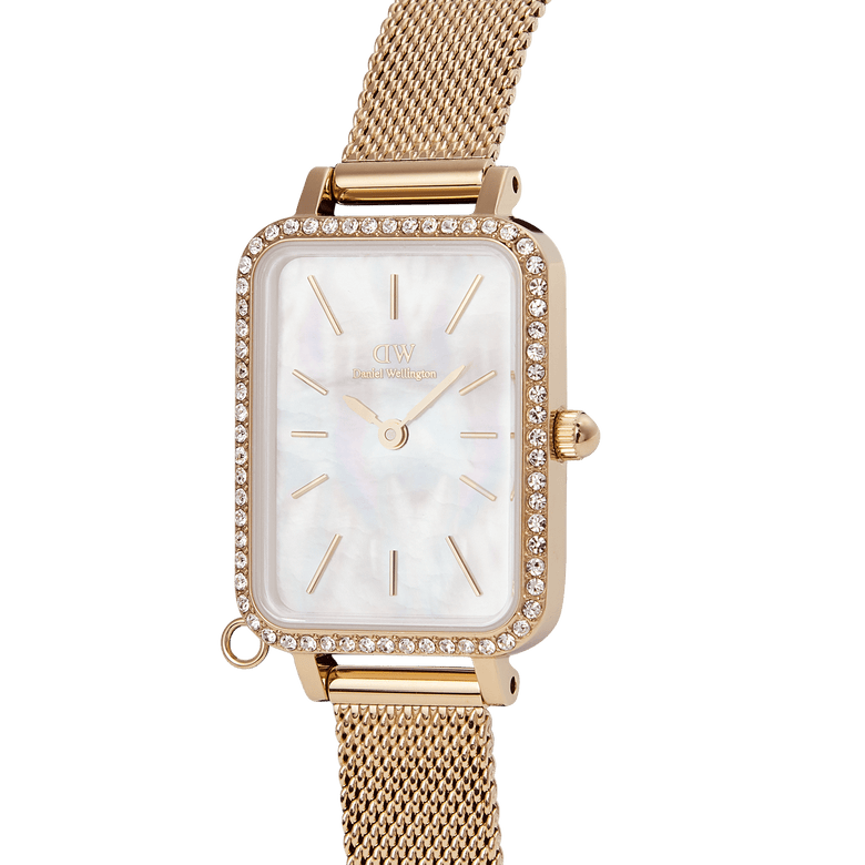 Quadro Crystal Zodiac Evergold gold watch for women with a rectangular crystal-framed bezel, mother of pearl dial, and adjustable gold mesh strap, shown in close-up detail.