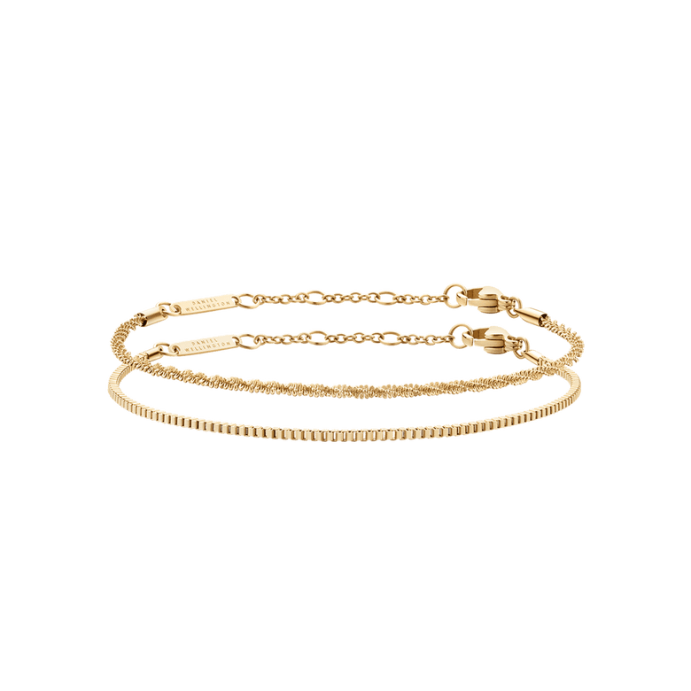 Two gold chain bracelets from the Staple Bracelet Set G, featuring delicate links and adjustable clasps, styled for versatile layering or solo wear.