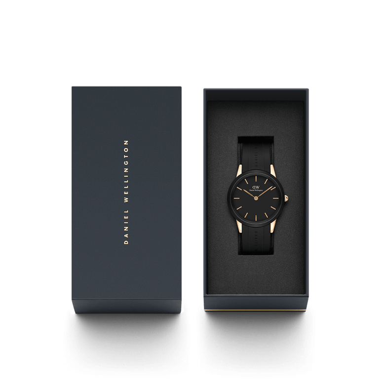Daniel Wellington Iconic Motion Rose Gold watch with a black dial and black FKM rubber strap, presented in an elegant branded gift box.