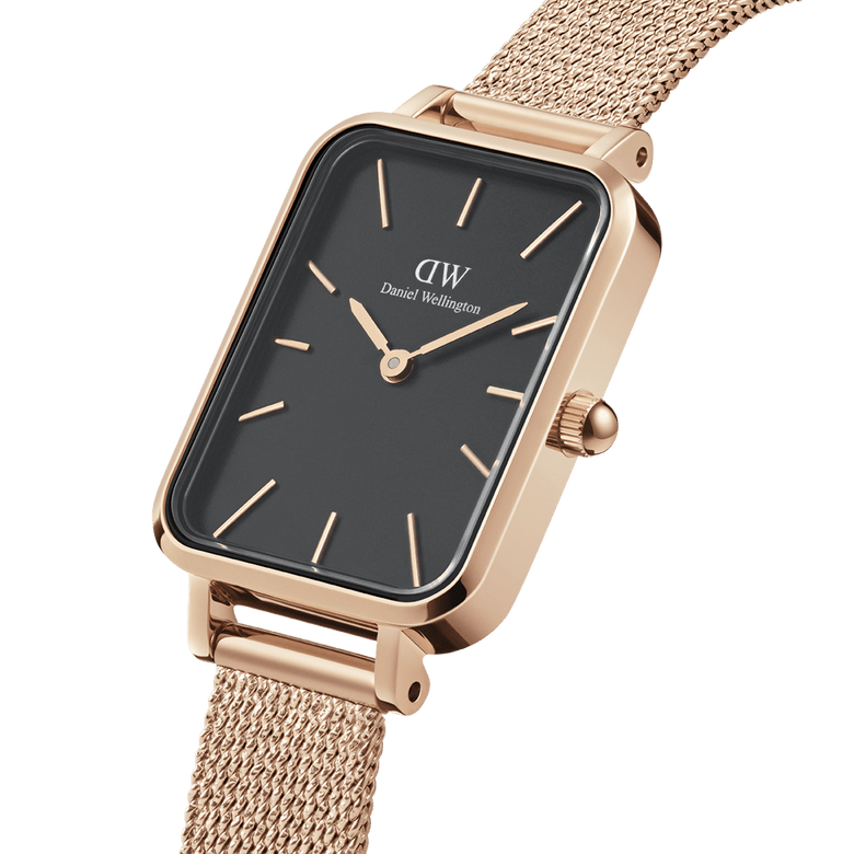 Close-up of the Quadro Pressed Melrose Black Rose Gold watch, showing its rectangular black dial, minimalist rose gold hour markers, and a finely woven rose gold mesh strap.