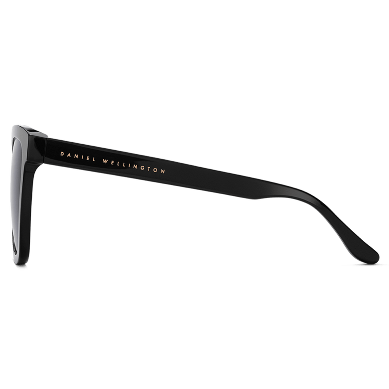 Side view of the Grande Bio-Acetate Black sunglasses showing the glossy black temple with Daniel Wellington branding and the oversized square frame design.
