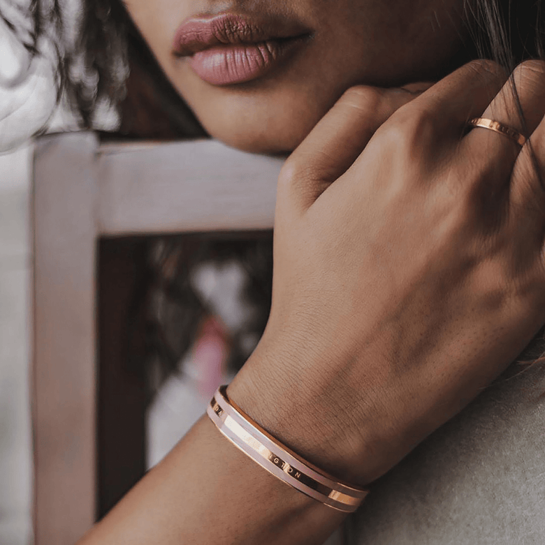 Emalie Bracelet Dusty Rose Rose Gold worn on the wrist, showing its wide cuff design with soft pink enamel and rose gold finish, styled with a matching rose gold ring for a modern, elegant look.