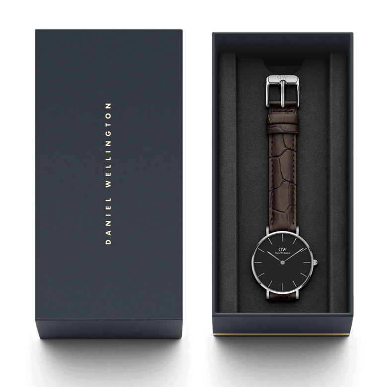 Petite York Black Silver ladies watch presented in a Daniel Wellington gift box, featuring a minimalist black dial, slim silver case, and croc-embossed dark brown leather strap.