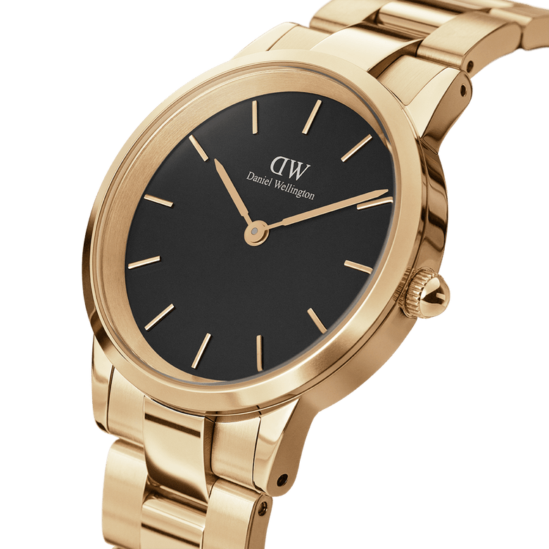 Close-up of the Daniel Wellington Iconic Link Black Gold watch showing its black minimalist dial, slim gold hour markers, and a polished gold stainless steel bracelet with a modern, elegant finish.