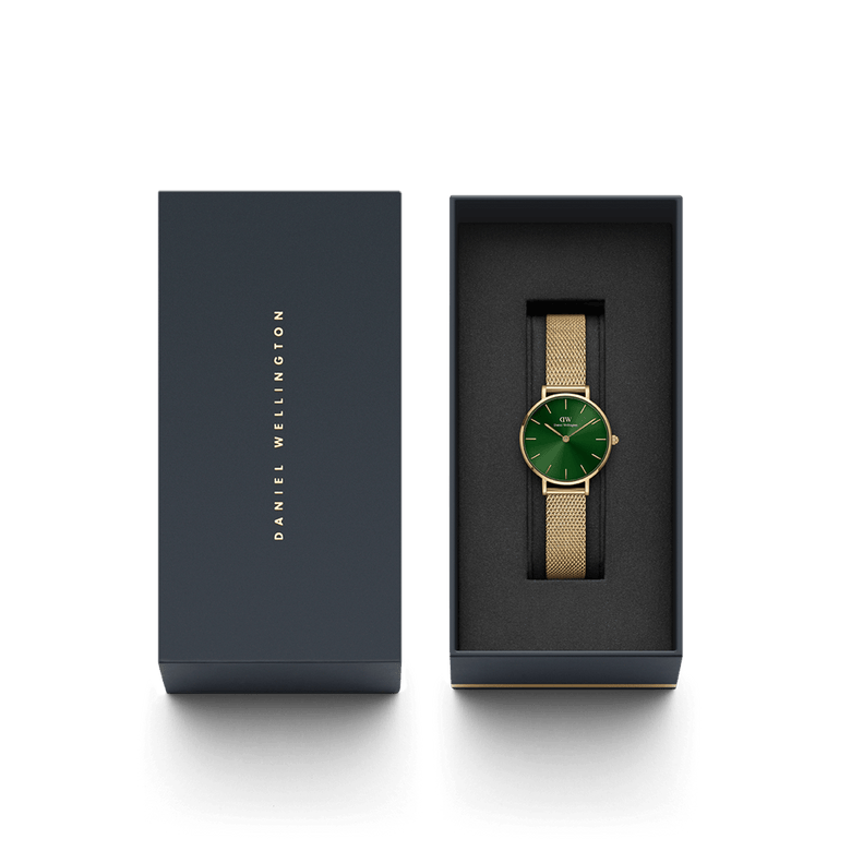 Petite Emerald gold mesh strap watch with an emerald green dial, elegantly presented in a black Daniel Wellington gift box.