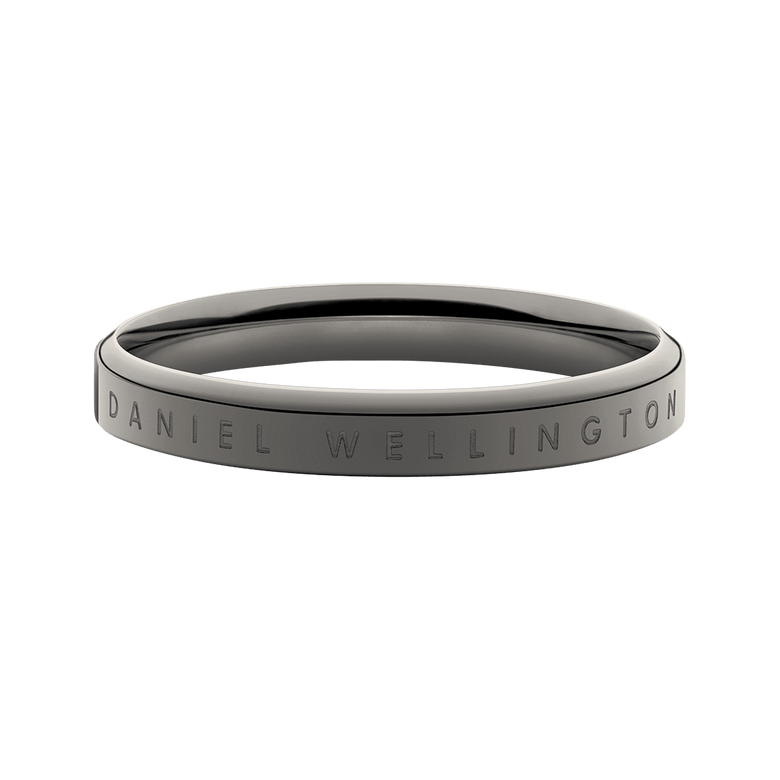 Classic Ring Graphite featuring a minimalist graphite-toned stainless steel band with engraved Daniel Wellington branding, shown in a close-up to highlight its smooth finish and modern silhouette.