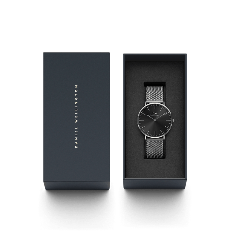 Classic Mesh Onyx silver watch with a black sunray dial and stainless steel mesh strap, elegantly presented in a Daniel Wellington branded gift box.