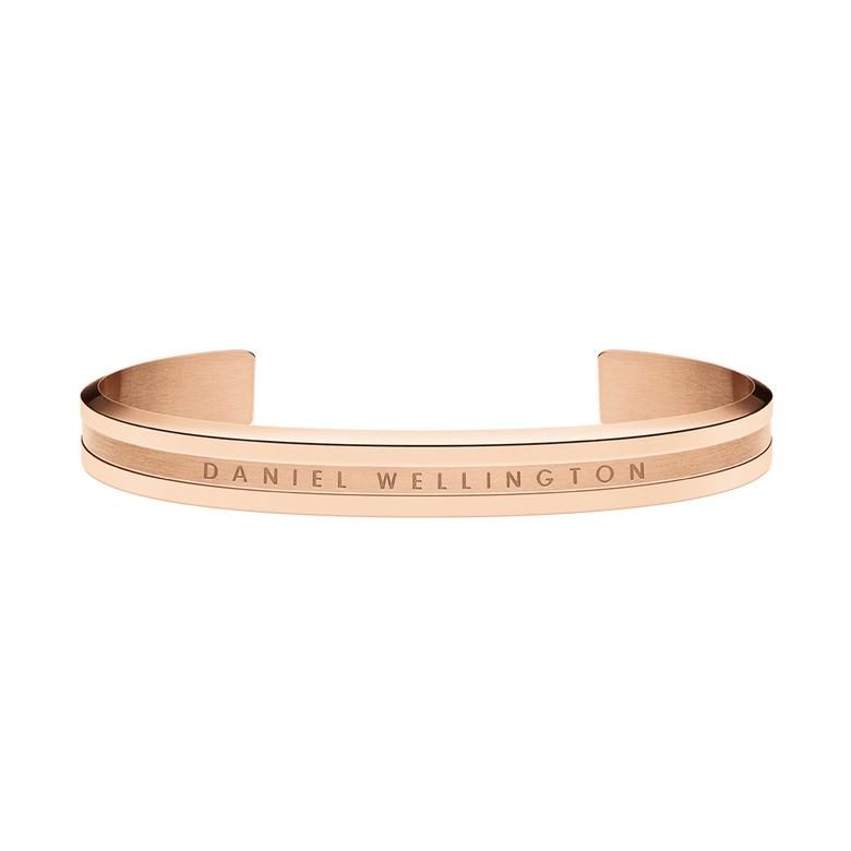 Minimalist Elan Bracelet Rose Gold by Daniel Wellington, featuring a warm rose gold tone, engraved logo, and open cuff style suitable for both men and women.
