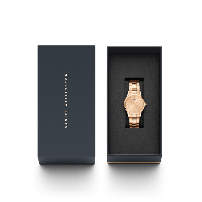 Iconic Link Unitone RG rose gold ladies watch with a polished link bracelet, presented in a sleek black Daniel Wellington gift box, ideal for gifting or adding to your collection.