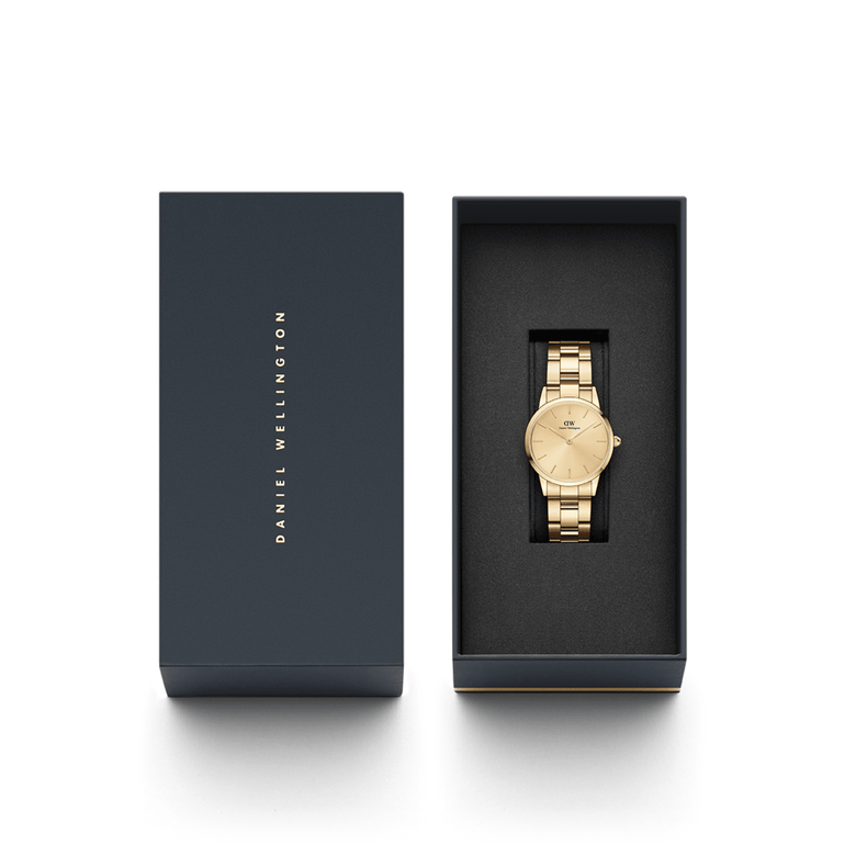 Daniel Wellington Iconic Link Unitone G gold watch with a 28mm dial, presented in a sleek black gift box with the brand name on the lid.