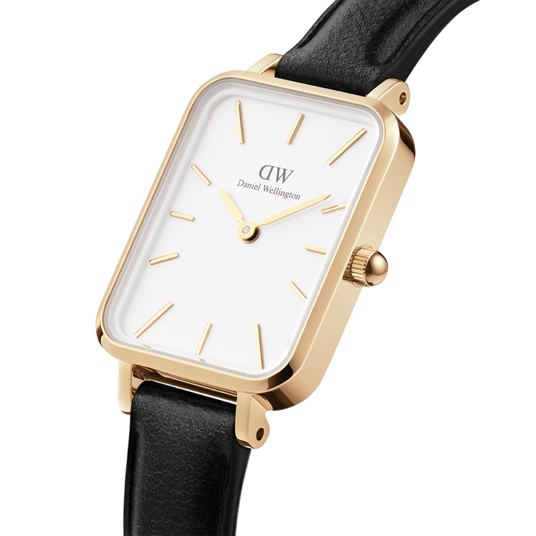 Quadro Pressed Sheffield Gold ladies watch with a rectangular gold stainless steel case, white dial, gold markers, and a slim black leather strap, shown in a close-up angled view.