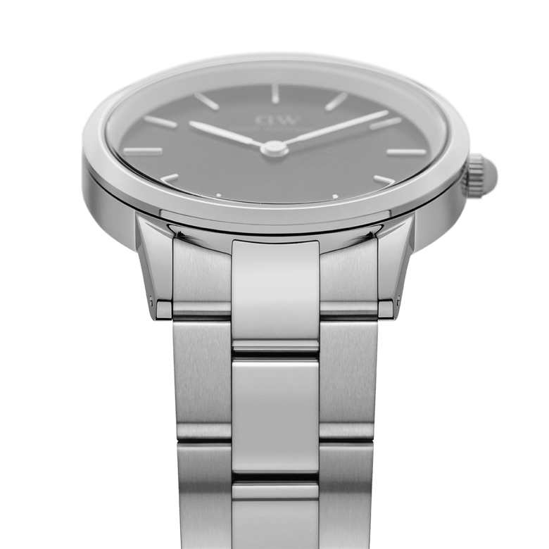 Daniel Wellington Iconic Link watch showcasing its brushed stainless steel link bracelet and sleek black dial from a side angle, highlighting the modern minimalist design.