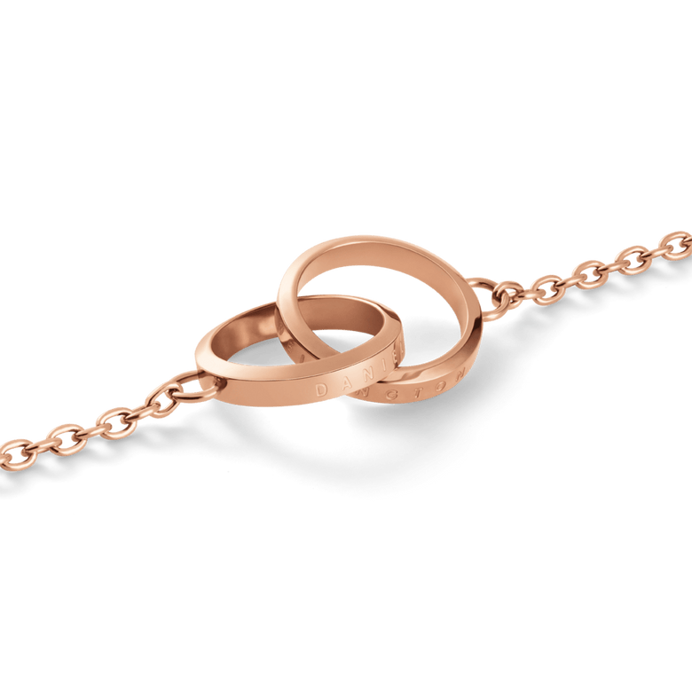 Close-up of the Elan Unity Necklace Rose Gold showing two interlocking polished rings engraved with subtle branding, attached to a fine rose gold chain.
