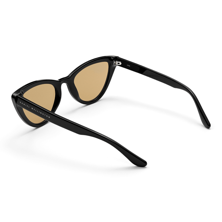 Lynx Bio-Acetate Black/Yellow sunglasses shown from the back angle, highlighting the durable black cat eye frame, yellow nylon lenses, and Daniel Wellington branding on the arm for a stylish designer finish.