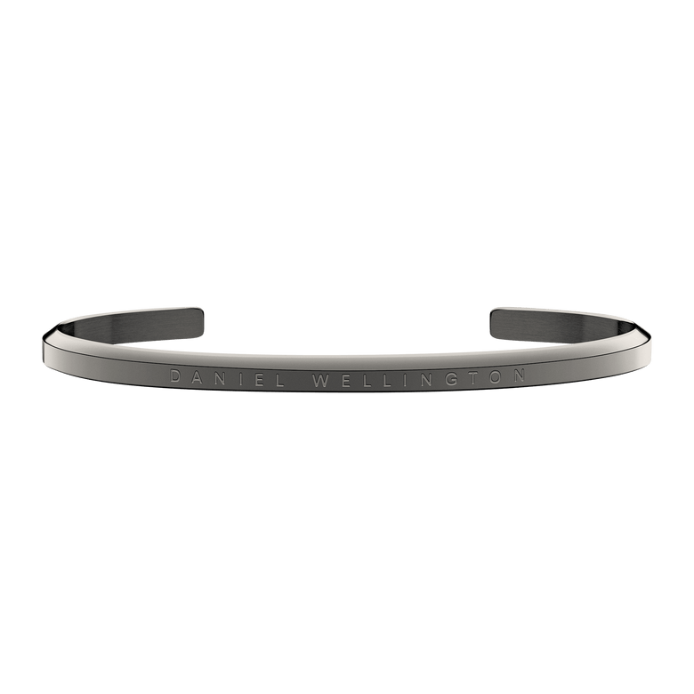 Classic Bracelet Graphite by Daniel Wellington featuring a slim open cuff design in dark grey stainless steel with subtle engraved branding, ideal for everyday wear or layering with a watch.