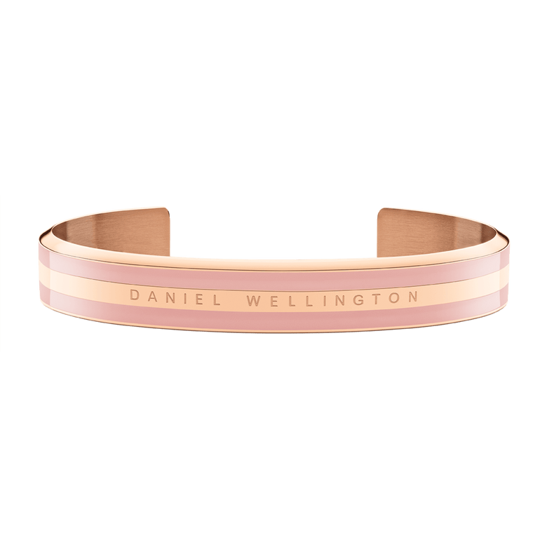 Emalie Bracelet Dusty Rose Rose Gold features a sleek open cuff design with soft pink enamel and rose gold double-plated stainless steel, displaying the Daniel Wellington logo across the front.