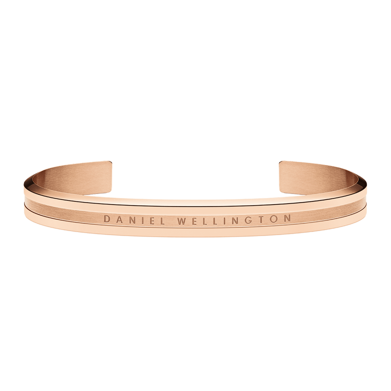 Rose gold Elan Bracelet with a sleek open cuff design, engraved Daniel Wellington logo, and polished finish, ideal for layering or everyday wear.