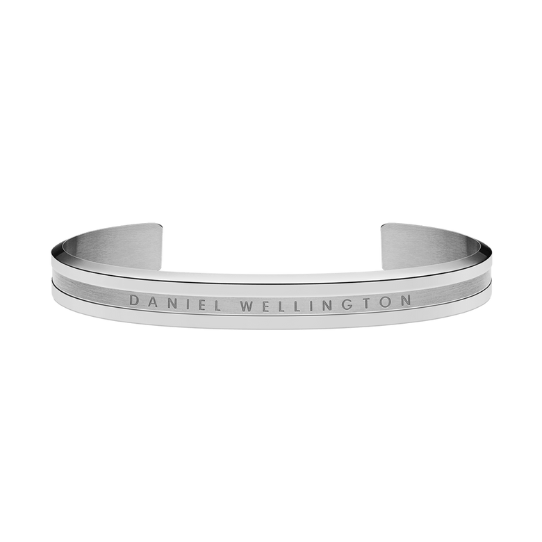 Minimalist silver cuff bracelet with a polished finish, featuring the engraved Daniel Wellington logo and a slim, open design suitable for both men and women.