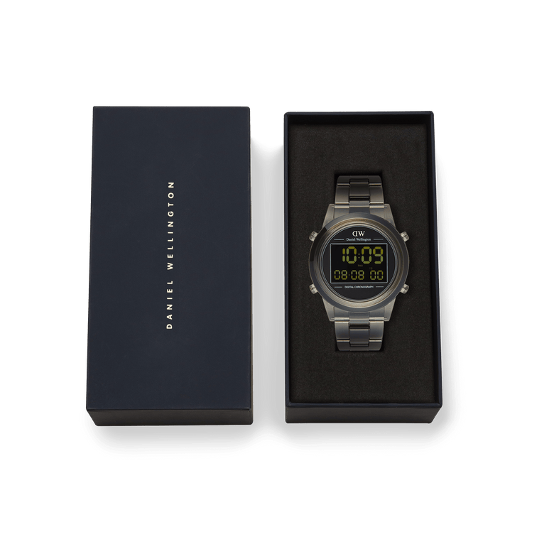 Daniel Wellington Retro Digital Dark Grey Dark Grey watch presented in its branded box, featuring a bold dark grey finish, digital display, and transparent bio-based plastic link strap.