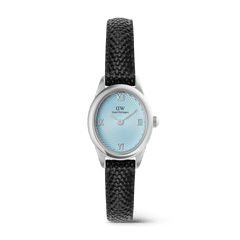 A petite women’s watch featuring an oval silver case, ice blue guilloché dial with silver Roman numerals, and a textured black lizard-embossed leather strap.
