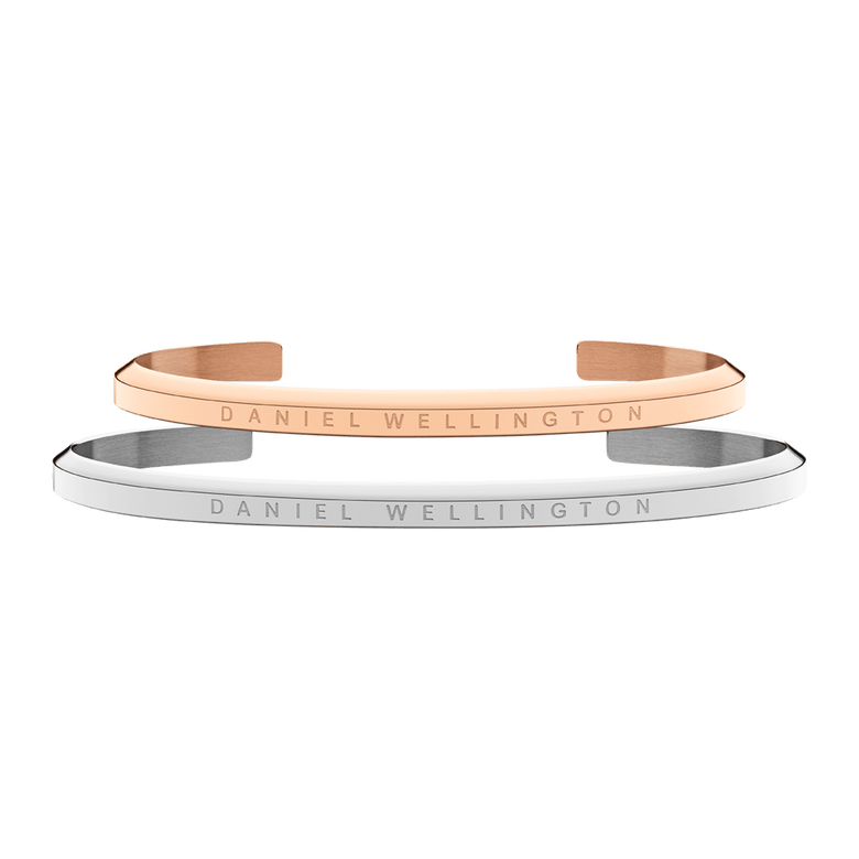 Classic Bracelet Rose Gold & Silver set featuring two slim, open cuff bracelets in polished rose gold and silver finishes, each engraved with the Daniel Wellington logo and designed for comfortable everyday wear.