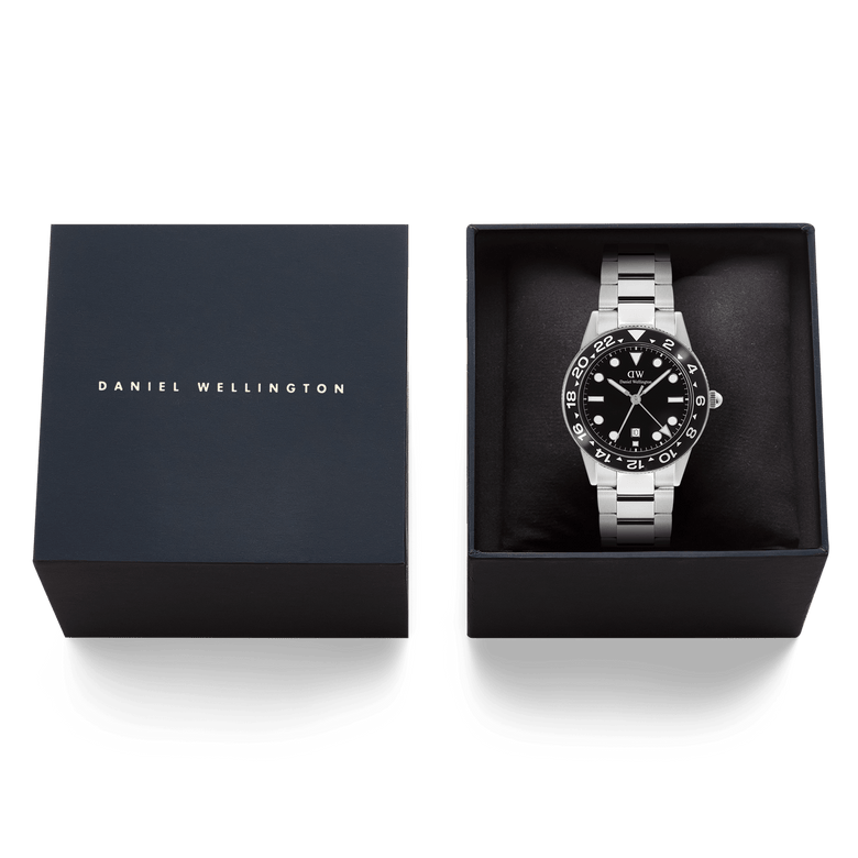 Daniel Wellington Iconic GMT Link Black Ceramic Bezel Silver watch presented in a branded gift box, featuring a stainless steel bracelet and bold black dial with ceramic bezel.