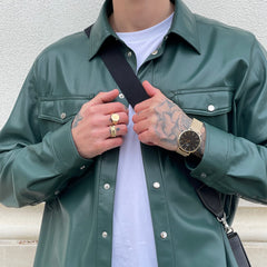 Classic Mesh Onyx Gold watch with a black sunray dial and gold mesh strap, worn on the wrist with a green leather jacket and white shirt, highlighting its versatile style for everyday wear.