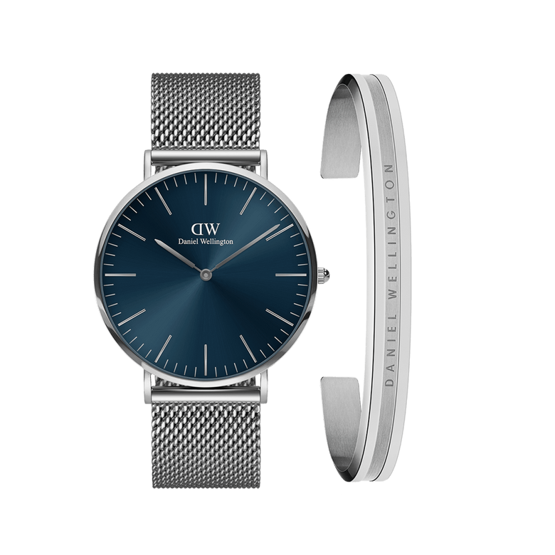 Classic Mesh Arctic + Elan Bracelet Silver set featuring a round watch with a deep blue dial and silver mesh strap, paired with a minimalist silver bracelet engraved with Daniel Wellington branding.