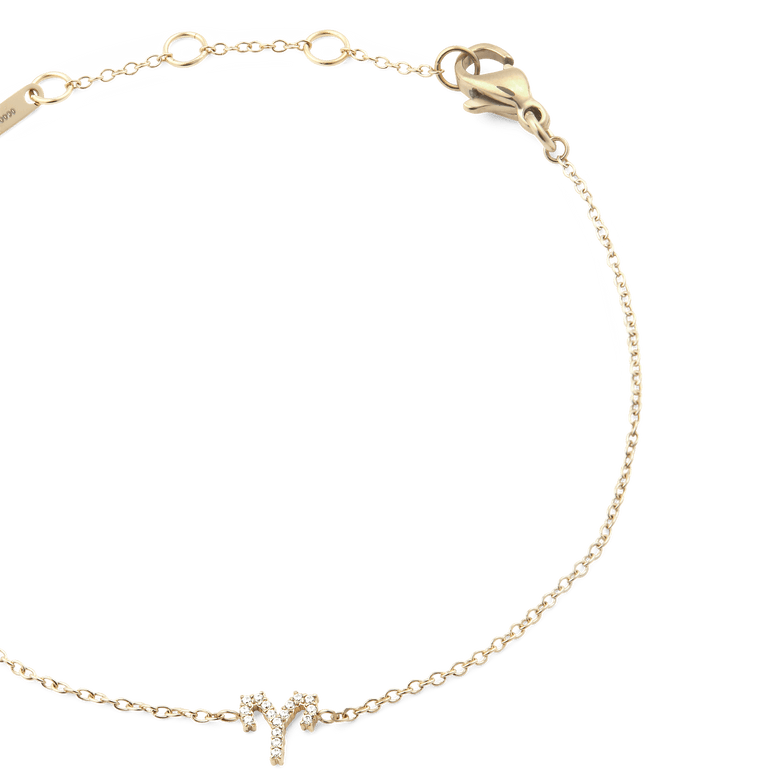 Close-up of the Crystal Zodiac Chain Bracelet Gold, featuring a fine gold chain with adjustable sizing rings and a crystal-encrusted Aries zodiac charm at the centre.