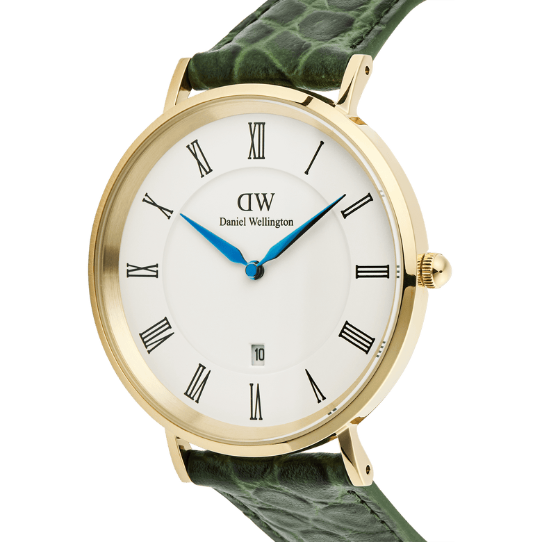 Close-up of the Classic Roman Numerals Date Dark Green Croc Belly Gold watch, featuring a gold-plated case, white dial with black Roman numerals, blue hands, date window, and a green crocodile-embossed leather strap.