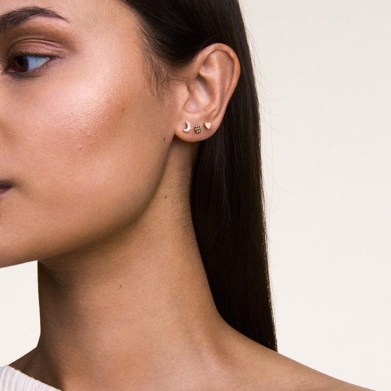 Heart Stud Silver earring worn in the second piercing, styled with other minimalist studs for a layered, modern look suitable for everyday wear.