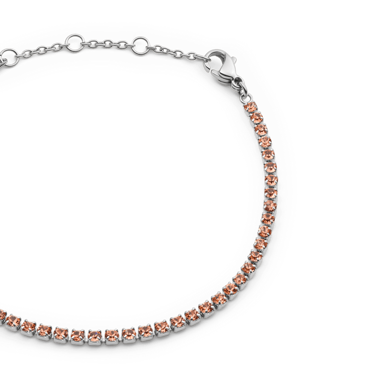 Close-up of the Classic Tennis Bracelet Apricot Silver, featuring apricot-coloured crystals set in a slim silver chain with an adjustable lobster clasp and sizing rings.