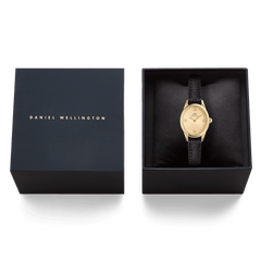 Daniel Wellington Ophelia Mini Black Lizard Unitone Guilloché Gold watch presented in a black gift box, featuring a gold oval case, textured gold dial, and black lizard-embossed leather strap.