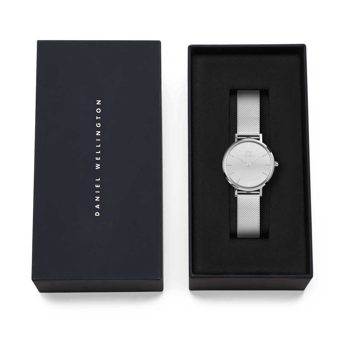 Daniel Wellington Petite Reflection Silver ladies watch with a mirror-effect silver dial and polished mesh strap, presented in an elegant black gift box with the brand name on the lid.