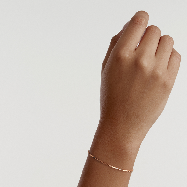 Box Chain Bracelet RG in rose gold worn on a wrist, showcasing its delicate box chain design and subtle, elegant finish suitable for everyday wear.