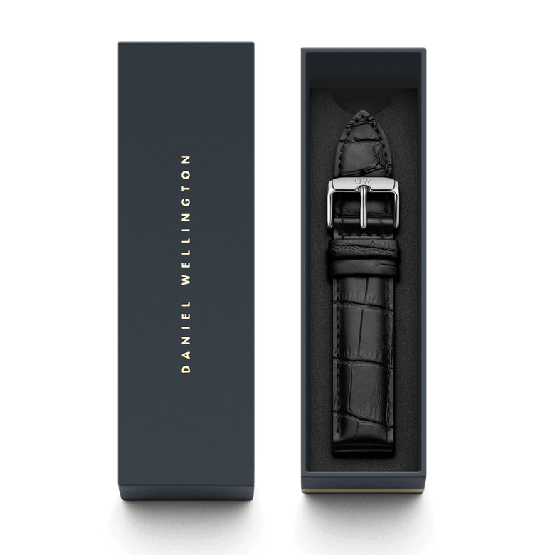 Reading Strap Silver leather watch strap in black with a croc-embossed finish and polished silver buckle, presented in a Daniel Wellington branded gift box.