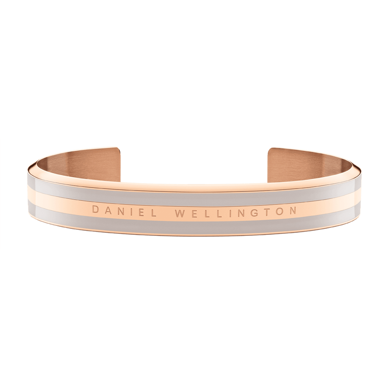 Wide rose gold cuff bracelet with desert sand enamel detailing and Daniel Wellington branding, featuring a smooth, minimalist design suitable for both men and women.