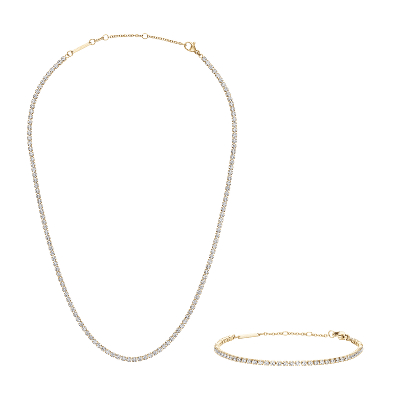 Polished gold tennis necklace and matching tennis bracelet, each featuring a row of sparkling stones and secure clasps, displayed against a plain background.