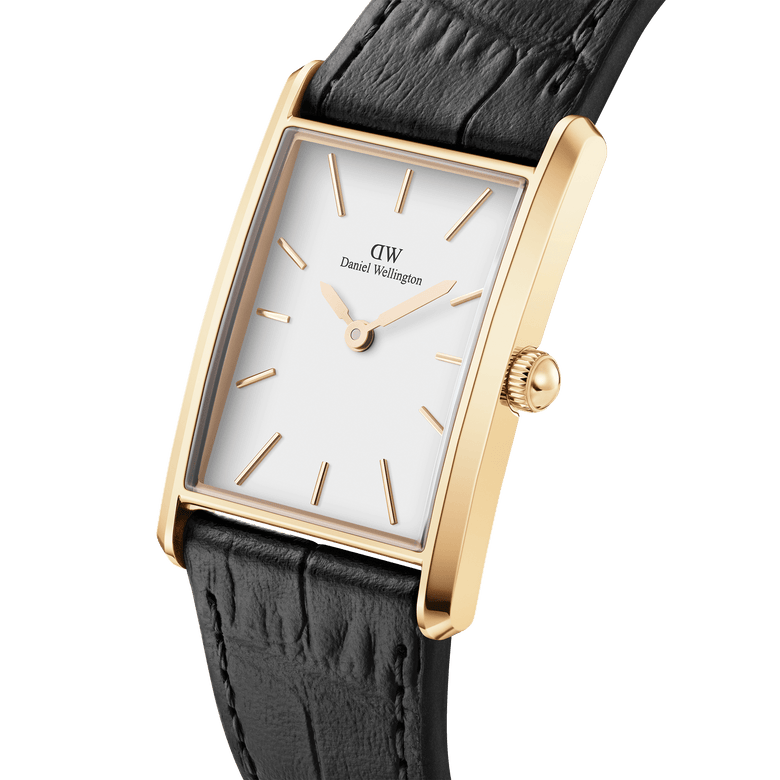 Daniel Wellington Bound Black Crocodile Gold watch featuring a rectangular gold case, minimalist white dial, and black crocodile-embossed leather strap, shown at an angle to highlight its slim profile and elegant detailing.