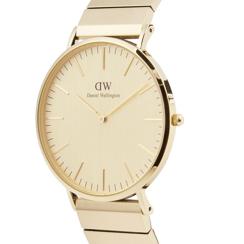 Classic Piano Link Gold Unitone watch with a brushed gold 40mm dial, minimalist hour markers, and a geometric piano link bracelet, shown from a side angle to highlight its slim profile and polished finish.
