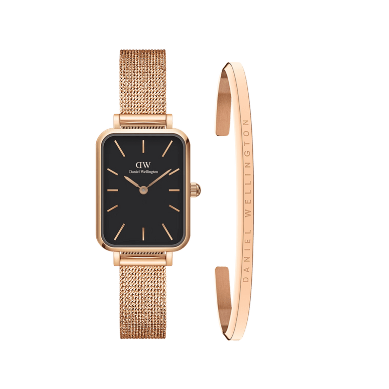 Rose gold ladies watch with a rectangular black dial and pressed mesh strap, paired with a slim rose gold bracelet featuring Daniel Wellington engraving, both designed for a refined and coordinated look.