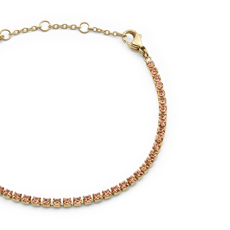 Close-up of the Classic Tennis Bracelet Apricot Gold showing apricot-coloured crystals set in gold, with adjustable sizing rings and a lobster clasp for a secure fit.