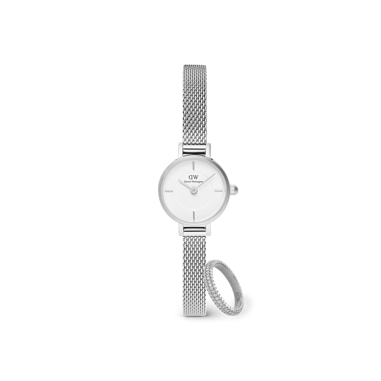 Silver Daniel Wellington Petite Mini mesh strap watch with a crisp white dial, paired with a pavé crystal ring featuring sparkling stones, both displayed against a plain background.