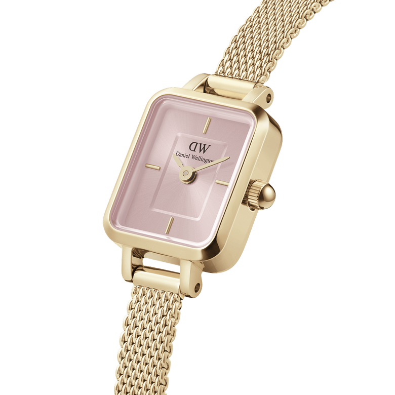 Quadro Mini Evergold Blush gold watch featuring a blush pink rectangular dial, minimalist hour markers, and a textured gold mesh strap, shown in a close-up angle highlighting its elegant design and contemporary finish.