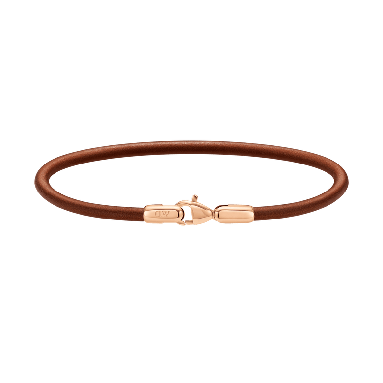 St Mawes Bracelet Rose Gold featuring a slim brown leather band and a rose gold-plated stainless steel lobster clasp, shown against a plain background.