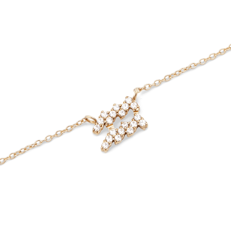 Close-up of the Crystal Zodiac Chain Necklace Gold featuring an Aquarius pendant set with sparkling crystals on a fine gold chain, highlighting its elegant and personal design.