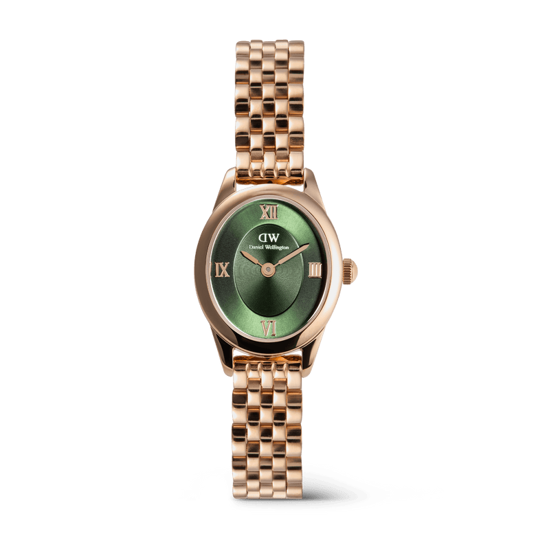 Rose gold ladies watch with an oval case, emerald green sunray dial featuring Roman numerals, and a beans link bracelet, designed for everyday elegance and versatility.