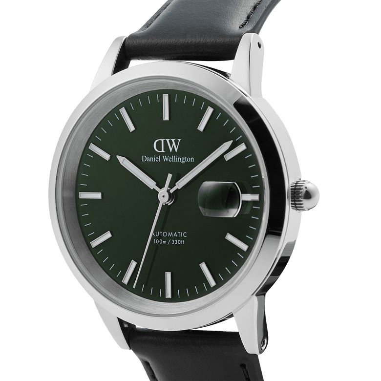 Close-up of the Iconic Sheffield Automatic Silver men's watch, featuring a polished silver case, emerald green enamel dial with luminous markers, magnified date window, and a black Italian leather strap.