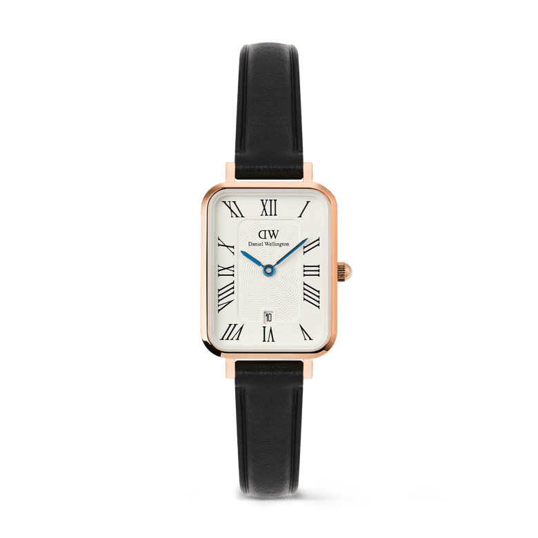 Quadro Roman Numerals Date Sheffield Rose Gold ladies watch with a rectangular rose gold case, white dial featuring bold Roman numerals, blue hands, date window at six o’clock, and a slim black leather strap.
